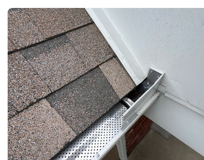 Micro-mesh gutter guard installed along a shingle roof edge