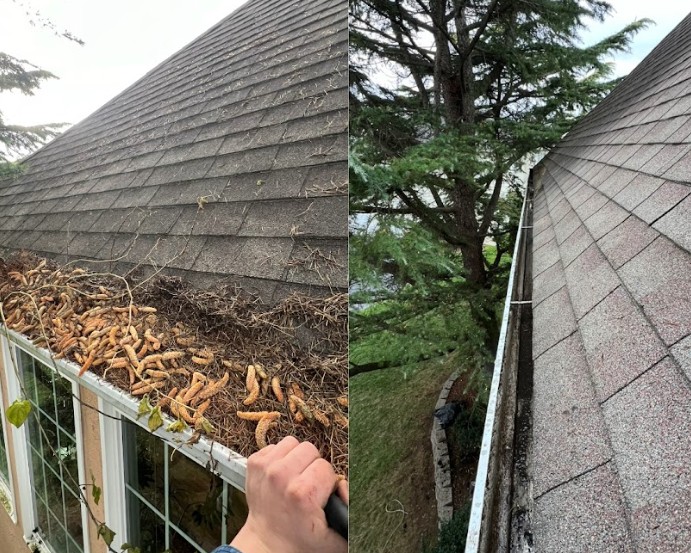 Technician clearing packed debris from a gutter by hand
