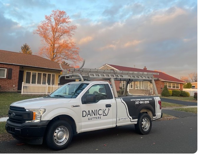 Danick Gutters truck parked at a customer home